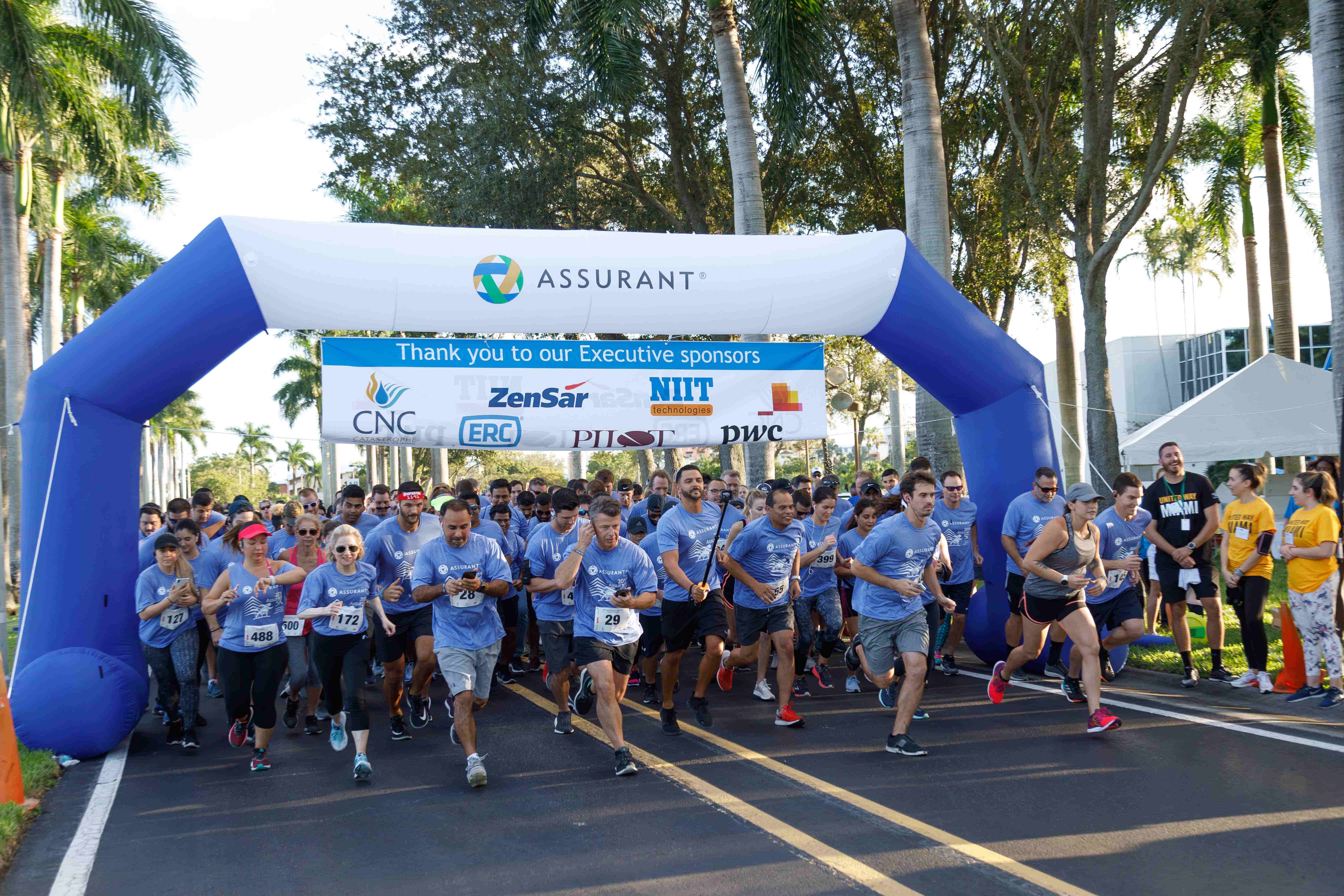 Assurant Team Racing A team of Assurant employees at the starting line of a 5K race