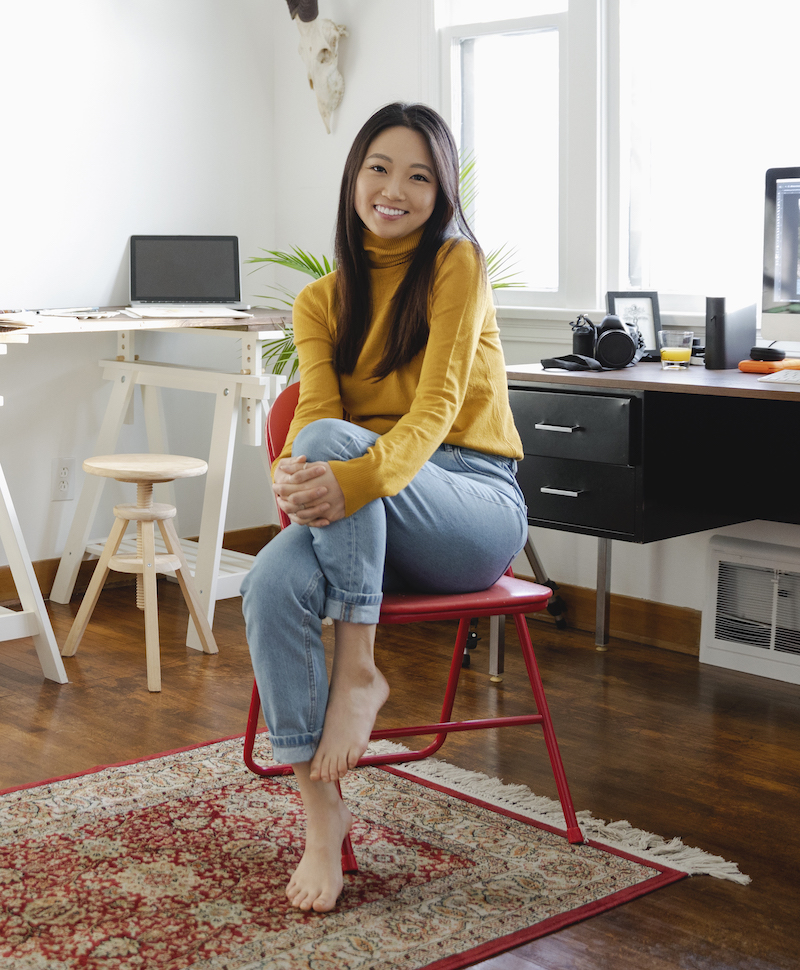 guynoshadow female assurant employee sitting and smiling at camera